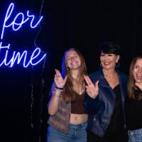 Three grads give anchor up sign with Philly